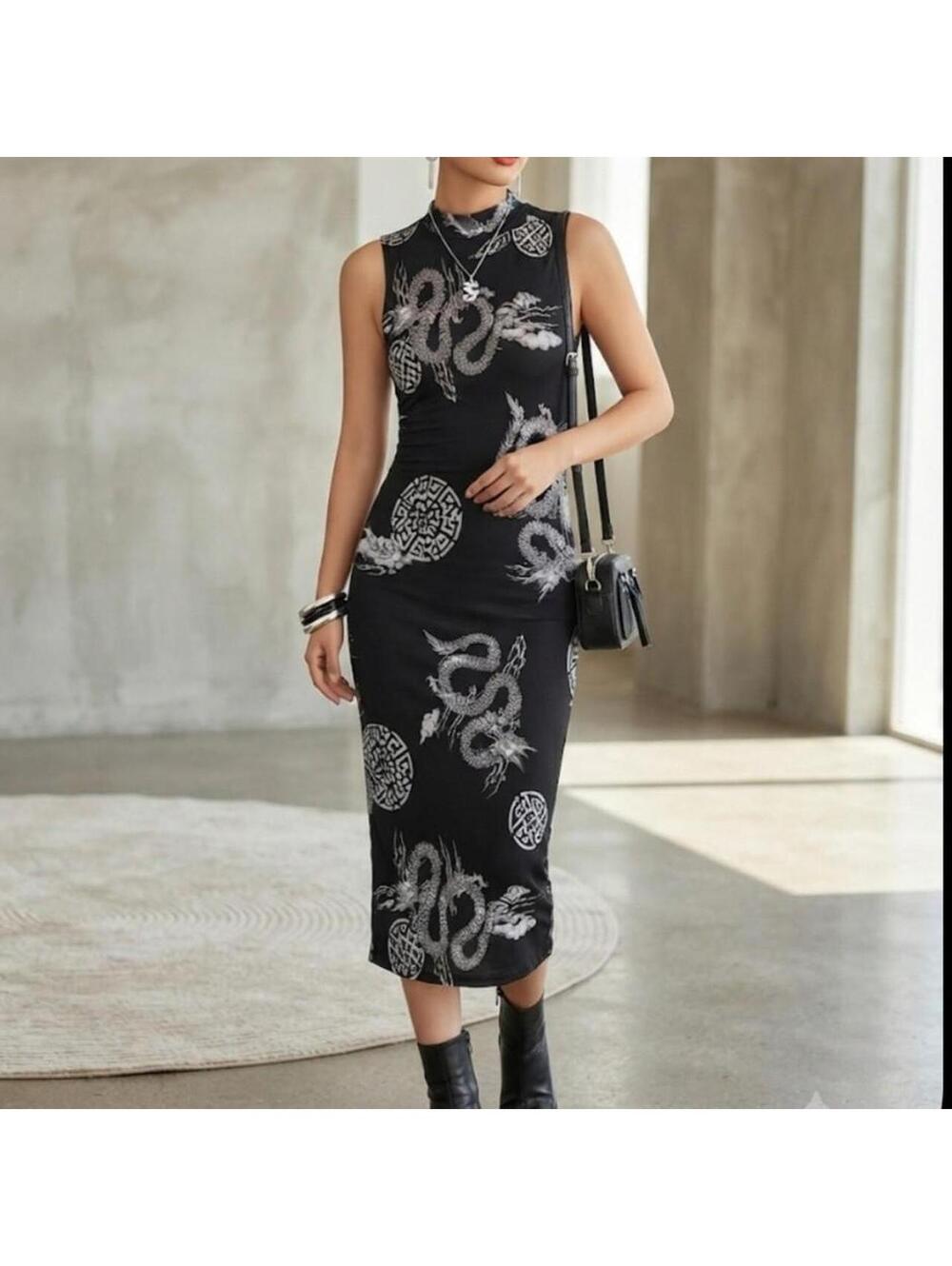This sleeveless, mock-neck midi dress features a striking black and white dress.